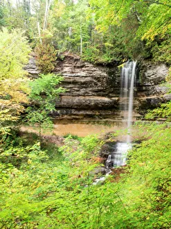 North America, USA, Michigan, Upper Peninsula. Munising Falls framed by hardwood forest in autumn North America, USA, Michigan, Upper Peninsula. Munising Falls framed by hardwood forest in autumn