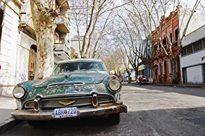 An old car rusty and flaky colour parked in the street, Green and white Desoto station An old car rusty and flaky colour parked in the street, Green and white Desoto station