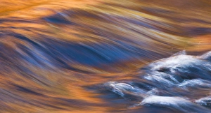 Painterly Impression of a rushing stream reflecting autumn colors Painterly Impression of a rushing stream reflecting autumn colors