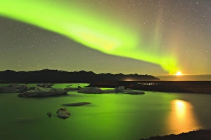 Rising moon and Aurora Borealis and moonrise over icebergs in Jokulsarlon and Breidamerkurjokull Rising moon and Aurora Borealis and moonrise over icebergs in Jokulsarlon and Breidamerkurjokull