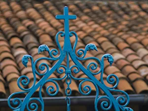 Santiago de Cuba, red tile roof and blue wrought iron cross Santiago de Cuba, red tile roof and blue wrought iron cross