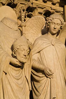 Sculpture on facade of Notre Dame Cathedral of Saint Denis after his martyrdom by decapitation Sculpture on facade of Notre Dame Cathedral of Saint Denis after his martyrdom by decapitation