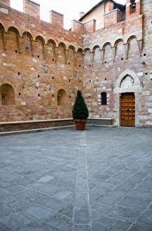 Sienna, Tuscany, Italy - The courtyard of an old world building with a single potted Sienna, Tuscany, Italy - The courtyard of an old world building with a single potted