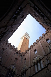Sienna, Tuscany, Italy - Low angle view looking up from the enclosed courtyard of an old Sienna, Tuscany, Italy - Low angle view looking up from the enclosed courtyard of an old