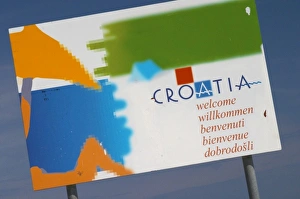 Sign saying Croatia Welcome with a picture of a person on a beach Orebic town, south Sign saying Croatia Welcome with a picture of a person on a beach Orebic town, south