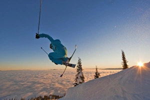 Skier catching air at sunset during an inversion at Whitefish Mountain Resort in Montana Skier catching air at sunset during an inversion at Whitefish Mountain Resort in Montana