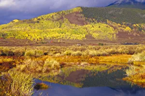 Small beaver pond with hillside of autumn colors near Crested Butte Small beaver pond with hillside of autumn colors near Crested Butte