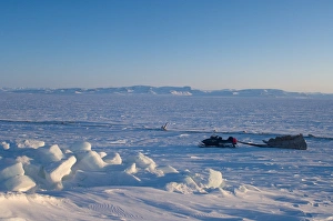 snow machine and sled on the frozen Arctic ocean, off Herschel island snow machine and sled on the frozen Arctic ocean, off Herschel island
