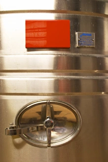 A detail of a stainless steel wine fermentation tank with the opening A detail of a stainless steel wine fermentation tank with the opening