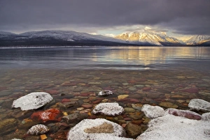 Sun breaks through the clouds at Lake McDonald on a winter evening in Glacier National Sun breaks through the clouds at Lake McDonald on a winter evening in Glacier National