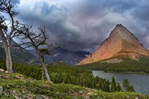 Sunrise light strikes Grinnell Point over Swiftcurrent Lake in Glacier National Park Sunrise light strikes Grinnell Point over Swiftcurrent Lake in Glacier National Park
