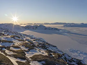 Sunrise during winter at the Ilulissat Icefjord, located in the Disko Bay in West Sunrise during winter at the Ilulissat Icefjord, located in the Disko Bay in West