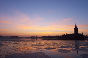 Sunset over an ice covered Riddarfjarden water towards the west with Kungsholmen Sunset over an ice covered Riddarfjarden water towards the west with Kungsholmen