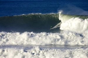 A surfer braves the gigantic surf at the Mavericks Big Wave Surf Competition in Northern A surfer braves the gigantic surf at the Mavericks Big Wave Surf Competition in Northern