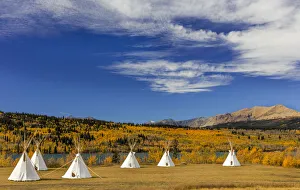 Tipis with Yellow Mountain in background at Chewing Black Bones campground near St Mary Tipis with Yellow Mountain in background at Chewing Black Bones campground near St Mary