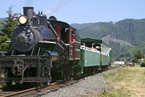 Tourists ride behind a 1910 Heisler Steam Locomotive at Garibaldi, Oregon, USA Tourists ride behind a 1910 Heisler Steam Locomotive at Garibaldi, Oregon, USA