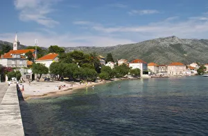 Tourists with the village and Mount Sveti Ilija mountain. Orebic town, holiday resort Tourists with the village and Mount Sveti Ilija mountain. Orebic town, holiday resort