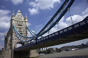 The Tower Bridge over the Thames River in London, England on a beautiful day with blue clouds The Tower Bridge over the Thames River in London, England on a beautiful day with blue clouds