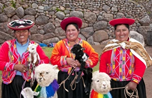 Traditional women with colorful clothes and llamas in religious region Saqsayhuaman Traditional women with colorful clothes and llamas in religious region Saqsayhuaman