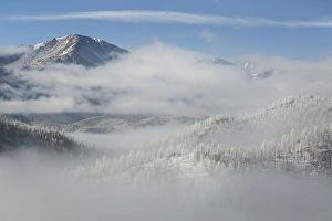 USA, Colorado. Clouds fill the valleys below Pikes Peak (14, 109ft - 4301m) on a frosty USA, Colorado. Clouds fill the valleys below Pikes Peak (14, 109ft - 4301m) on a frosty