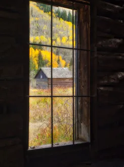 USA, Colorado. Looking out a window in the ghost town of Ashcroft in autumn near Aspen USA, Colorado. Looking out a window in the ghost town of Ashcroft in autumn near Aspen
