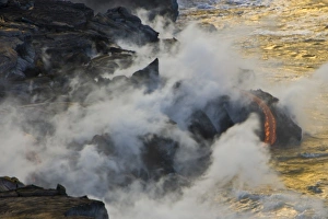 USA. Molten lava flows into the ocean at sunrise in Volcanoes NP on the Big Island of USA. Molten lava flows into the ocean at sunrise in Volcanoes NP on the Big Island of