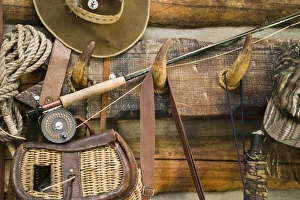 USA, Montana. Fishing ger and hat hang on horn pegs outside of log cabin USA, Montana. Fishing ger and hat hang on horn pegs outside of log cabin