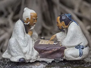 Vietnam, Hanoi. Temple of Literature, painted ceramics of 2 men playing traditional game Vietnam, Hanoi. Temple of Literature, painted ceramics of 2 men playing traditional game