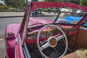 View into driver's seat of classic convertible pink American car parked in Vieja View into driver's seat of classic convertible pink American car parked in Vieja