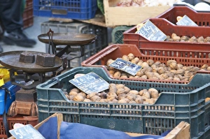 Walnuts for sale in plastic ctrates baskets at a market stall at the market in Bergerac Walnuts for sale in plastic ctrates baskets at a market stall at the market in Bergerac
