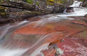 Water cascades down the red rock of Virginia Creek in Glacier National Park, Montana, USA Water cascades down the red rock of Virginia Creek in Glacier National Park, Montana, USA