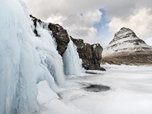 Waterfall Kirkjufellsfoss on Snaefellsnes peninsula during winter Waterfall Kirkjufellsfoss on Snaefellsnes peninsula during winter