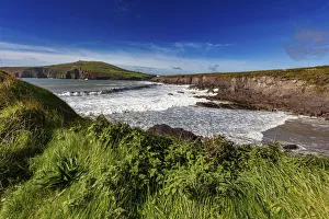 Waves crash into cliffs at Binn Ban Beach near Dingle, Ireland Waves crash into cliffs at Binn Ban Beach near Dingle, Ireland