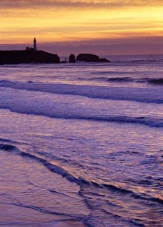 Waves wash in by the Yaquina Head Lighthouse at sunset, near Newport, on the Oregon Coast Waves wash in by the Yaquina Head Lighthouse at sunset, near Newport, on the Oregon Coast