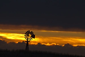 Windmill slihouetted against the sunset in the sandhills region of Loup County, Nebraksa Windmill slihouetted against the sunset in the sandhills region of Loup County, Nebraksa