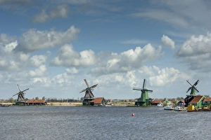 WIndmills along a lake in a peaceful country scene WIndmills along a lake in a peaceful country scene