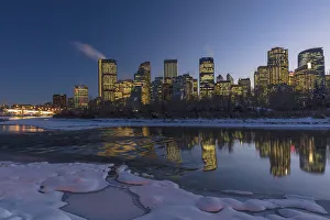 Winter city skyline reflects in the Bow River in Calgary, Alberta, Canada Winter city skyline reflects in the Bow River in Calgary, Alberta, Canada