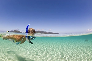 woman (age 23) enjoying snorkeling the clear tropical waters of a remote island woman (age 23) enjoying snorkeling the clear tropical waters of a remote island