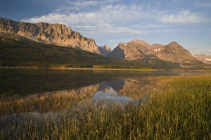 Wynn and Allen Mountains reflect into calm Lake Sherburne in Glacier National Park Wynn and Allen Mountains reflect into calm Lake Sherburne in Glacier National Park