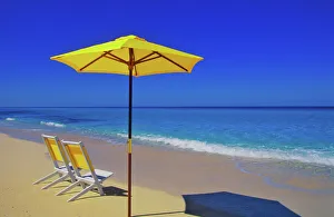 Yellow beach umbrella and chairs on pristine beach, Bimini Island, Bahamas Yellow beach umbrella and chairs on pristine beach, Bimini Island, Bahamas