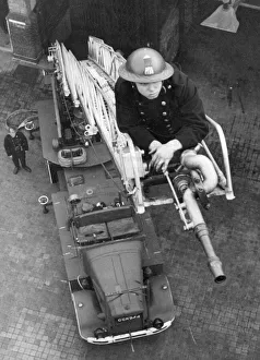 Blitz in London -- AFS firefighter on ladder, WW2 Blitz in London -- AFS firefighter on ladder, WW2