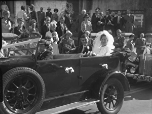 Bride and Groom in open top motor car Bride and Groom in open top motor car