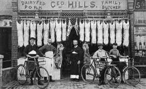 Print of a group outside a butchers shop in Worthing, c1905