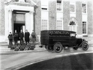 Prints of Four men and a boy posing with typewriters and Remington Typewriter Co Ltd delivery van in foreground. Photographic Collection West Sussex Record Office Ref No: PH 17977 Sussex Prints: Print of four men and a boy with typewriters on County Hall steps