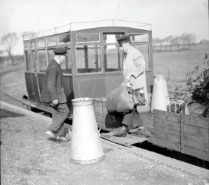 Prints of Ford railcar set on the curve at Selsey Station with livestock, goods and empty milk churns being unloaded from the centre wagon. The Selsey Tramway opened in 1897 and formed part of Col Railway Prints: Print of a Ford railcar at Selsey Station