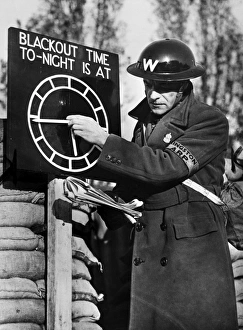 An air raid warden setting a blackout time clock indicator at an Air Raid Precautions post on the outskirts of London An air raid warden setting a blackout time clock indicator at an Air Raid Precautions post on the outskirts of London