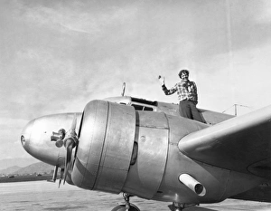 Prints of AMELIA EARHART (1897-1937). American aviator. Sitting atop her Electra 10E in Los Angeles, just before departure for Oakland and her planned circumnavigation of the globe. Photograph, 10 March 1937 Pioneer Prints: Amelia Earhart Print: Electra 10E in Los Angeles