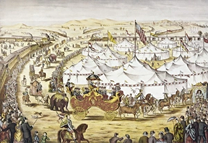 AMERICAN CIRCUS, c1874. The Grand Layout. Circus parade around tents with a crowd watching alongside a railroad train AMERICAN CIRCUS, c1874. The Grand Layout. Circus parade around tents with a crowd watching alongside a railroad train