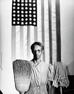 AMERICAN GOTHIC, 1942. Ella Watson, a US Government Chairwoman. Photograph by Gordon Parks, 1942 AMERICAN GOTHIC, 1942. Ella Watson, a US Government Chairwoman. Photograph by Gordon Parks, 1942