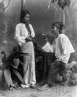BURMA: WOMEN. Two Burmese women, one standing and one seated, smoking a cigar. Photograph BURMA: WOMEN. Two Burmese women, one standing and one seated, smoking a cigar. Photograph